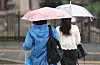 Commuters walk with umbrellas at Gwanghwamun Intersection in central Seoul on June 20 as a heavy rain advisory is issued across the capital with the start of the monsoon season. [NEWS1]