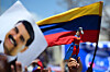 A supporter of Venezuelan President and presidential candidate Nicolas Maduro raises a dummy of the character known as ″Super Bigote,″ which represents Maduro, during his campaign closing rally in Maracaibo, Zulia State, Venezuela on July 25, 2024. [AFP/YONHAP]