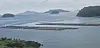 A shade cover is draped over fish cages for red seabream and rockfish in the waters off a coastal village in Sanyang-eup, Tongyeong, South Gyeongsang, on July 30. [KIM MIN-JU]
