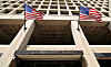 U.S. flags flutter in the wind over the entrance to the J. Edgar Hoover Building, on the day that FBI Director Kash Patel announced that he was redeploying 1,500 FBI agents and shutting down the bureau’s storied headquarters, in Washington, D.C., U.S., on May 16. [REUTERS/YONHAP]