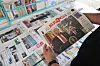 A person holds a newspaper showing U.S. President Donald Trump and his Middle East envoy, Steve Witkoff, in Tehran on May 11. [REUTERS/YONHAP]