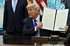 U.S. President Donald Trump shows a signed document as he signs executive orders and proclamations in the Oval Office at the White House, in Washington. on May 5, 2025. [REUTERS/YONHAP]