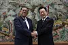 South Korean President Lee Jae Myung, right, shakes hands with Japanese Prime Minister Shigeru Ishiba at the APEC House in Busan on Sept. 30. [JOINT PRESS CORPS]
