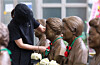A citizen places hand-knitted camellia flower necklaces on the busts of victims of Japanese military sexual slavery at the House of Sharing in Gwangju, Gyeonggi, on Aug. 14, International Memorial Day for Japanese Military “Comfort Women.” [NEWS1]