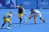 India's Abhishek Abhishek, right, battles for the ball with Australia's Eddie Ockenden, center, and Aran Zalewski during the men's field hockey match at the Yves-du-Manoir Stadium in Colombes, France om Friday. [AP/YONHAP]