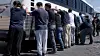 Detainees are made to stand against a bus before being handcuffed, during a raid by federal agents where about 300 Koreans were among 475 people arrested at the site of a $4.3 billion project by Hyundai Motor and LG Energy Solution to build batteries for electric cars in Savannah, Georgia on Sept. 4. [REUTERS/YONHAP]