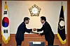 Rho Tae-ak, chairperson of the National Election Commission (NEC) at left, gives the NEC's certification over to Democratic Party floor leader Park Chan-dae, confirming Lee Jae-myung as the president-elect of Korea on June 4 in Gwacheon, Gyeonggi. [NEWS1]