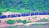 North Korean soldiers work somewhere along the border in the demilitarized zone in a photo provided by the South’s Joint Chiefs of Staff Tuesday. [JOINT CHIEFS OF STAFF]