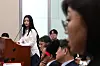NewJeans member Hanni, left, stares at the head of her agency ADOR, Kim Ju-young, at the National Assembly on Oct. 15 [JOINT PRESS CORPS]