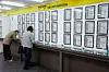 People fill out forms in front of a job information board at the Seoul Western Employment and Welfare Plus Center in Mapo District, western Seoul, on Nov. 12. [NEWS1]
