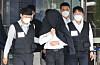 A junior doctor, identified only by his surname Jeong, is escorted by police out of the Seoul Central District Court in Seocho District, southern Seoul, after attending his arrest warrant review on Friday. The court later approved an arrest warrant against Jeong, who is accused of compiling a list of junior doctors who have not joined their colleagues' mass walkout to protest the government's plan to increase annual medical recruitment. [NEWS1]