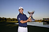 Tom Kim, also known as Kim Joo-hyung, poses with the trophy after putting in to win on the 18th green during the final round of the Shriners Children's Open at TPC Summerlin in Las Vegas, Nevada on Sunday.  [GETTY IMAGES]