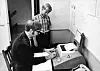 Microsoft co-founders Paul Allen, front, and Bill Gates with a teletype machine from the Lakeside yearbook for the 1969-70 school year [LAKESIDE SCHOOL]