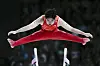 Boheng Zhang of China competes on the parallel bars during a men's artistic gymnastics qualification round at the Paris Olympics in Paris on Saturday. [AP/YONHAP]