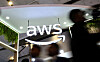 People walk past the logo of Amazon Web Services (AWS) at its exhibitor stall at the India Mobile Congress 2025 at Yashobhoomi, a convention and expo center in New Delhi, India, Oct. 8, 2025. [REUTERS/YONHAP]