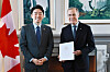 Kang Hoon-sik, left, President Lee Jae Myung's chief of staff, and Canadian Prime Minister Mark Carney pose for a photo after Kang delivered Lee's personal letter to Carney, in this photo captured from Kang's Facebook account. [YONHAP]