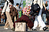 Pedestrians carry around their puffer jackets amid the relatively warm weather in central Seoul on Dec. 7. [YONHAP]