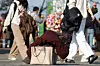 Pedestrians carry around their puffer jackets amid the relatively warm weather in central Seoul on Dec. 7. [YONHAP]