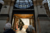 Customers look at a Prada shop window, in Milan, Italy, on Dec. 2. [AP/YONHAP]