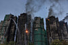 Smoke rises from apartments after a major fire swept through several blocks at the Wang Fuk Court residential estate in Hong Kong's Tai Po district on Nov. 27. Hong Kong firefighters were scouring a still-burning apartment complex for hundreds of missing people on Nov. 27, a day after the blaze tore through the high-rises, killing at least 44. [AFP/YONHAP]