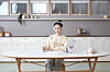 An adult works on her Kumon worksheets. [KYOWON]