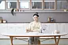 An adult works on her Kumon worksheets. [KYOWON]