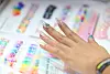 A visitor tries out nail products at Coex in Gangnam District, southern Seoul, on April 25. [YONHAP]