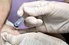 A healthcare worker administers a flu vaccine on a patient at a hospital in Guro District, western Seoul, on April 11. [NEWS1]