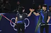 Korea's Jeong Yeong-seok, right, and Kim Seon-yeong celebrate after winning the mixed doubles round robin phase of the curling competition against the United States at the 2026 Milan-Cortina Winter Olympics in Italy on Feb. 7. [AP/YONHAP]