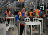 Workers carry components at NextStar Energy's battery plant in Ontario, Canada. [YONHAP]