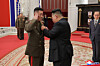 An undated photo released by the official Korean Central News Agency (KCNA) on Aug. 22 shows North Korean leader Kim Jong-un, right, fixing a hero medal onto a soldier's uniform during a ceremony to award state commendations to commanders and combatants deployed in unspecified overseas operations, in Pyongyang, North Korea. [EPA/YONHAP]