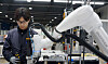 A worker is seen working with Doosan Robotics' collaborative robot model ″M.″ [DOOSAN ROBOTICS]