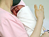 A newborn is seen in the arms of a nurse at a hospital in Guro District, western Seoul on May 28. [NEWS1]