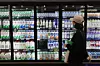 A shopper looks at milk at a supermarket in Seoul on Oct. 8. [YONHAP]