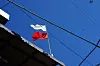 Red and white flags are displayed on top of a shaman's shindang in Seoul. Korean shamans' shrines are often indicated through flags hung outside their doors. While there are many different interpretations for the flags' colors, a white flag usually indicates that the shaman is able to tell clients' fortune, while the red flag says the shaman can also perform gut. [KIM JU-YEON]
