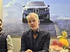 Adrian van Hooydonk, the head designer of BMW Group, speaks during an interview with the Korean press on the sidelines of the IAA Mobility 2025 in Munich on Sept. 8. The background photo features the newly unveiled iX3, the car for which van Hooydonk supervised the overall design. [BMW KOREA]