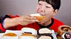 Mukbang videos on the viral Yonsei Cream Milk Bread were popular during 2022 and 2023. This picture shows Hong Sound, a YouTuber with over 1.85 million subscribers, eating one of the buns in his video. [SCREEN CAPTURE]