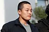 Police officers escort Terraform Labs co-founder Do Kwon after he served a sentence for document forgery, in Podgorica, Montenegro on March 23, 2024. [REUTERS/YONHAP]