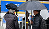 People cover their heads during the morning commute in Jongno District, central Seoul, on April 14 as rain falls nationwide. [NEWS1]