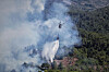 A Turkish helicopter drops water on the flames as it helps fight a wildfire near the town of Rabia, in Syria's Latakia countryside on July 7. [AP/YONHAP]
