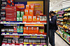 A customer examines health supplements at a CU convenience store in Jung District, central Seoul, on March 12. [YONHAP]