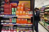 A customer examines health supplements at a CU convenience store in Jung District, central Seoul, on March 12. [YONHAP]