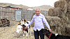 Byambasuren Davaajav, 65, a dairy farmer from a village of Jargalant, poses for a photograph with his cattle at his house in Ulaanbaatar in Mongolia on April 15. [GLOBAL CIVIC SHARING]