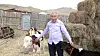 Byambasuren Davaajav, 65, a dairy farmer from a village of Jargalant, poses for a photograph with his cattle at his house in Ulaanbaatar in Mongolia on April 15. [GLOBAL CIVIC SHARING]