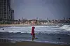 A woman walks along the beach, in Tel Aviv, Israel, on June 24, after Israel and Iran on Tuesday have accepted a cease-fire plan proposed by U.S. President Donald Trump. [AP/YONHAP]