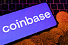 A smartphone with the Coinbase logo and representation of cryptocurrency are placed on a keyboard in this illustration from June 8, 2023. [REUTERS/YONHAP]