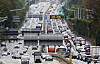 Vehicles crawl along the northbound lane, pictured left, and southbound lane of the Gyeongbu Expressway near Jamwon Interchange in Seocho District, southern Seoul, on Oct. 7. [NEWS1]