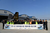 Officials pose for a group photo to mark the completion of flight tests for Korea's first homegrown KF-21 fighter jet under development on Jan. 13. [DEFENSE ACQUISITION PROGRAM ADMINISTRATION]