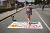 A tourist walks on a banner that reads buses are for neighbors not for toursim, while anti-tourism activists across southern Europe team up to pressure authorities to take action against overcrowded cities as they prepare to participate in simultaneous large-scale protests across Spain, Portugal and Italy on June 14. [REUTERS/YONHAP]