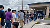 Korean workers wait in line in front of a United States Immigration and Customs Enforcement detention facility in Georgia on Sept. 8. [YONHAP]